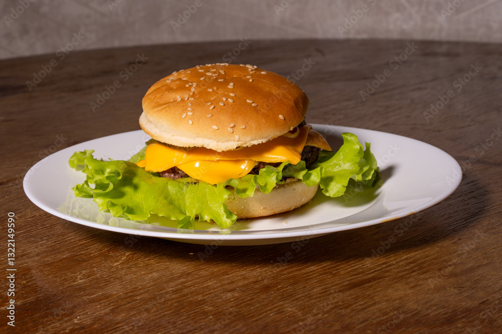 A juicy cheeseburger with a sesame seed bun, melted cheese, beef patty, and lettuce on a white plate, styled atop a rustic wooden background.