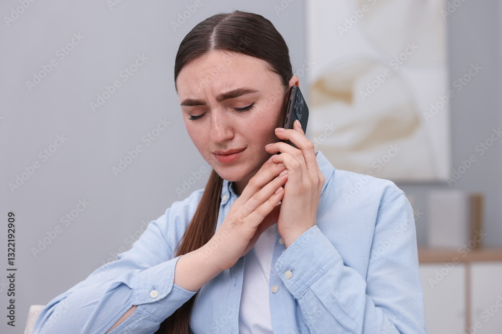 Stressed woman calling hotline for mental health help at home Stressed woman calling hotline for mental health help at home