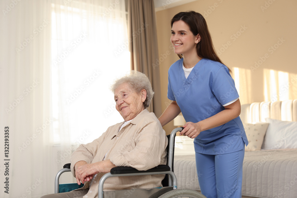 Fototapeta premium Healthcare worker with elderly woman in wheelchair indoors
