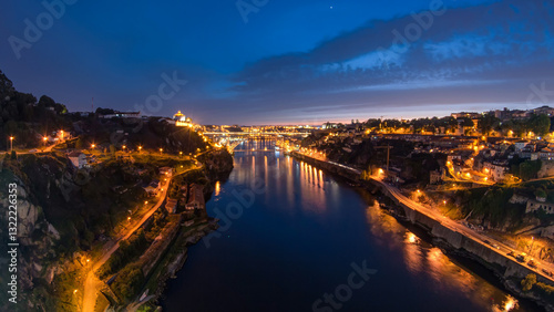 Fototapeta Naklejka Na Ścianę i Meble -  Day to night view of the historic city of Porto, Portugal timelapse with the Dom Luiz bridge