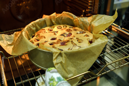 Mother and son are preparing a cherry cake together