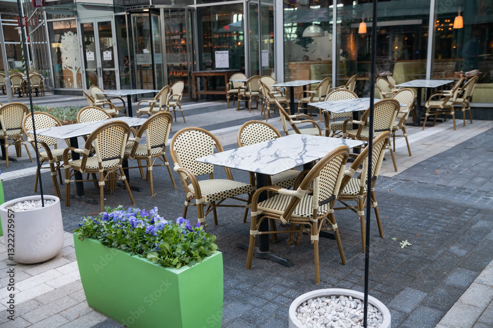 Naklejka premium cozy empty street cafe outdoors. Tables, chairs and umbrellas.