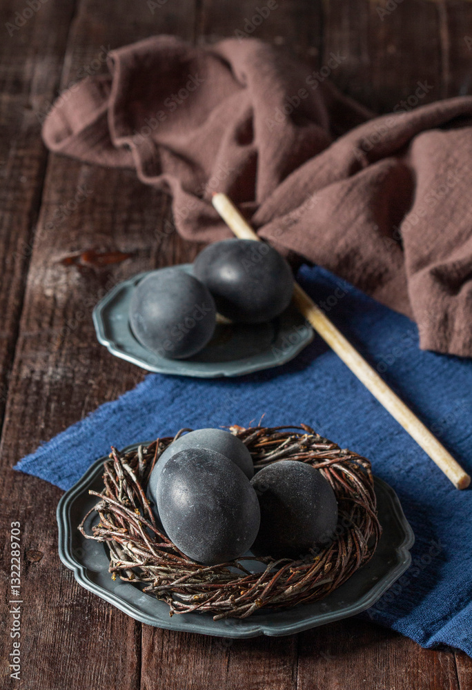 Wine painted eggs in a nest, bird feathers, drapery on a wooden background. Easter concept. Wine painted eggs in a nest, bird feathers, drapery on a wooden background. Easter concept.