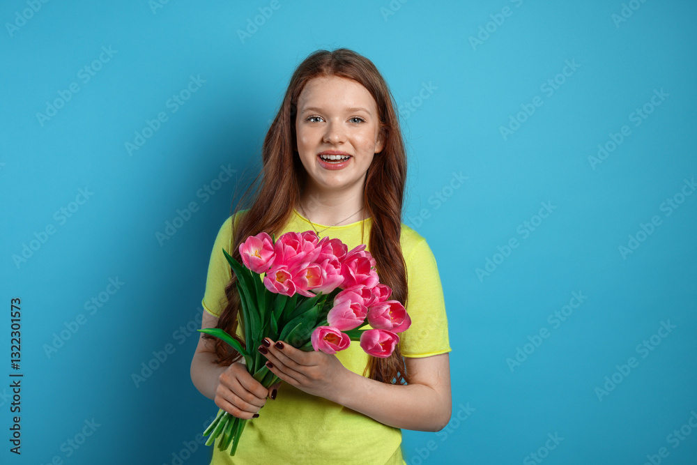 Beautiful teenage girl with bouquet of tulips on light blue background Beautiful teenage girl with bouquet of tulips on light blue background