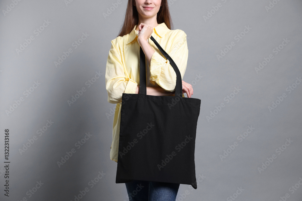 Φωτογραφία Woman with blank shopper bag on grey background, closeup