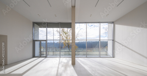 Modern spacious room with large windows and natural views