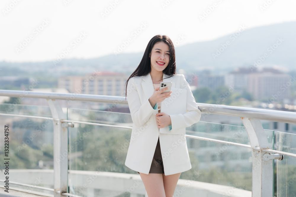 Fototapeta premium Smiling Businesswoman with Phone on Balcony