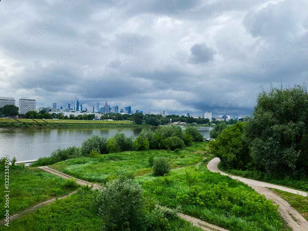 City skyline view with river and greenery under a cloudy sky. Warsaw, Poland. City skyline view with river and greenery under a cloudy sky. Warsaw, Poland.