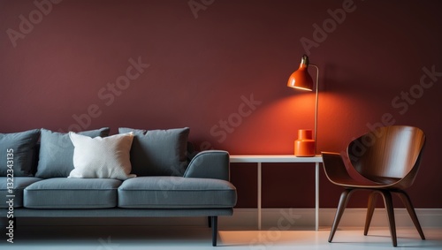 Modern claret red wall feature with white background, grey sofa and pillow, white bookshelf coffee table and orange lamp design, frame and chair decoration.