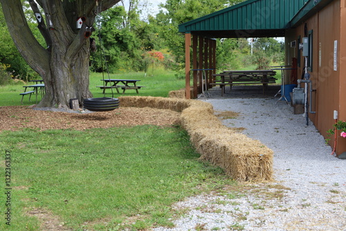 square haybales along a picnic and playground area photo