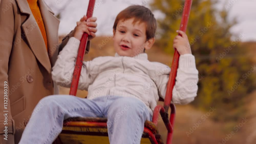 Mother swings son on swing in park. Mother swings son on cute swing in park echoing with laughter. Mother swings son in park sharing moments on swing with laughter filling air making experience Mother swings son on swing in park. Mother swings son on cute swing in park echoing with laughter. Mother swings son in park sharing moments on swing with laughter filling air making experience