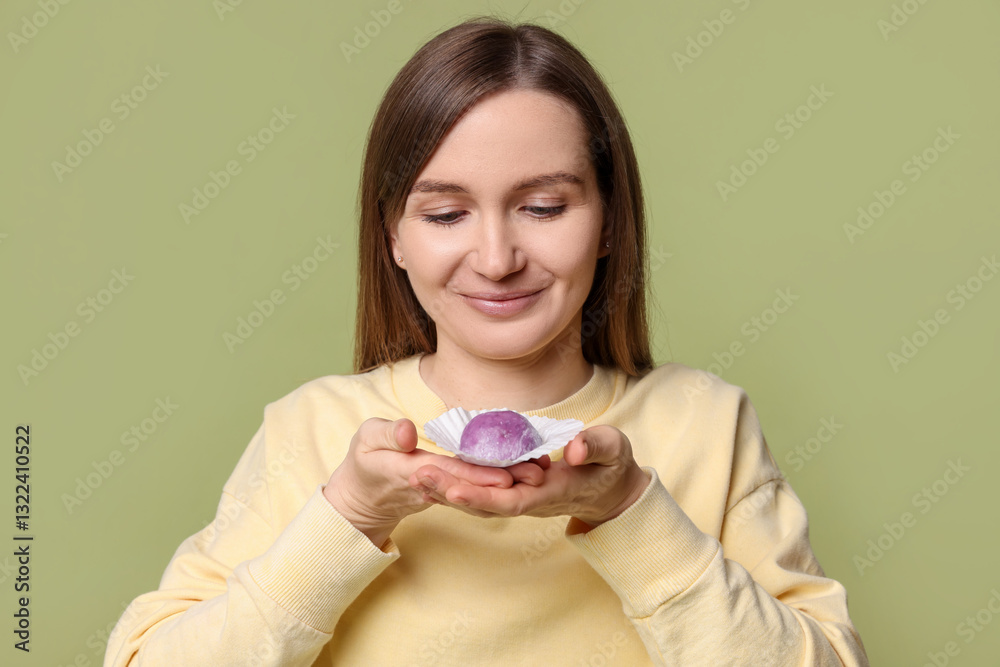 Woman with tasty mochi on olive background Woman with tasty mochi on olive background