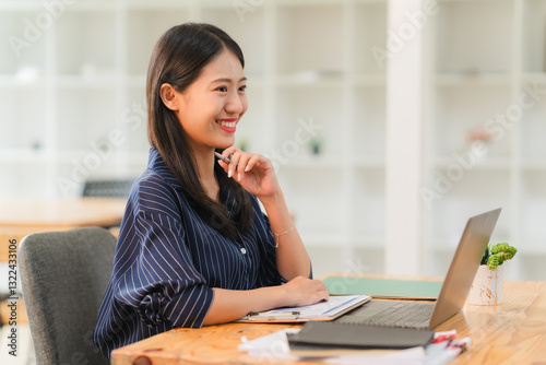 Smiling Asian Woman Working at Desk