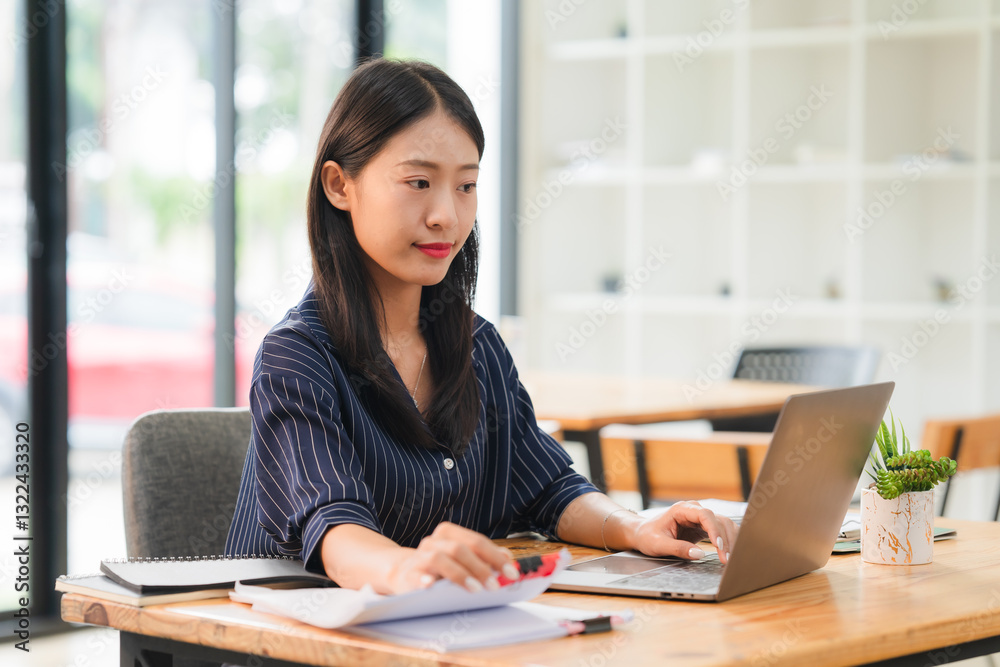 Asian Woman Working at Desk with Laptop Asian Woman Working at Desk with Laptop