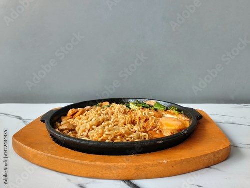 Hot Noodles with Egg and Vegetables on a hot plate
