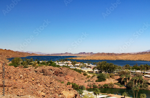 View of Lake Havasu and Colorado River with homes near Lake Havasu City, Arizona, USA with view of California and blue sky copy space.