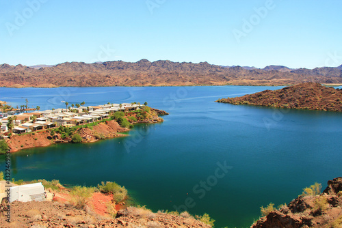 View of Lake Havasu and Colorado River with homes near Lake Havasu City, Arizona, USA with view of California and blue sky copy space.