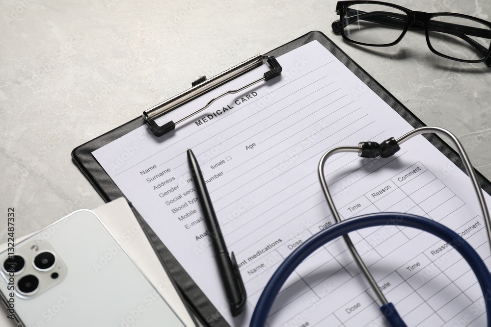 Composition with medical card form and pen on grey background, closeup Composition with medical card form and pen on grey background, closeup
