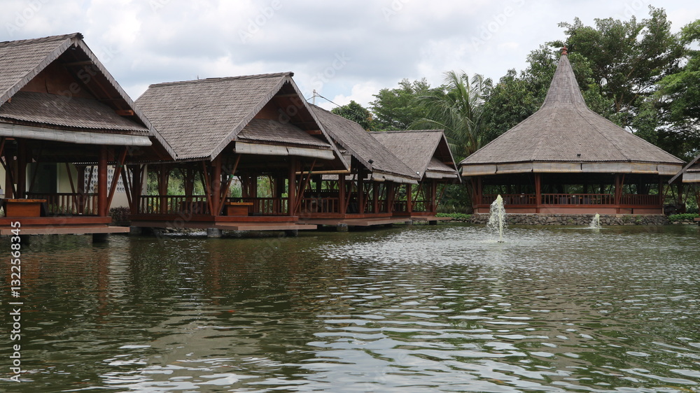 Saung (gazebo) or resting place made of bamboo above a fish pond. Saung (gazebo) or resting place made of bamboo above a fish pond.