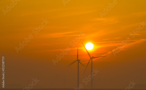 Wallpaper Mural Wind turbine for renewable energy in an orange foggy and cloudy sky at sunrise in winter, oostvaardersplassen, almere, flevoland, netherlands, March 10, 2025 Torontodigital.ca