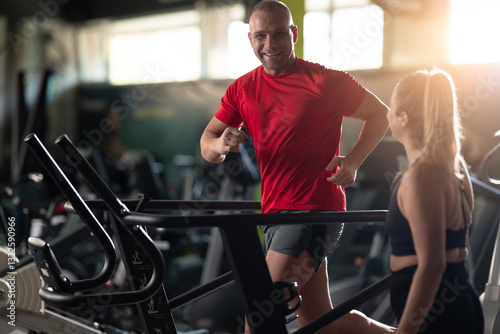 A couple working together in the gym, performing a conditioning workout side by side, supporting each other with strength, motivation, and teamwork. photo