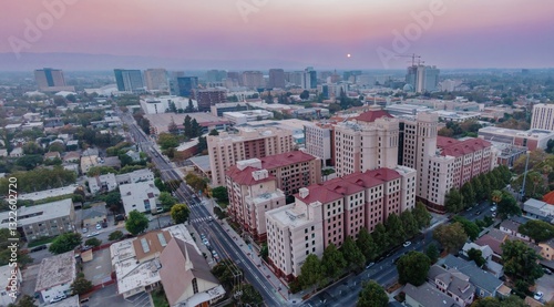 Aerial view of San Jose State University (SJSU), California, USA, showcasing the urban landscape at sunset. The photo captures the city's architecture and layout, highlighting urban development.