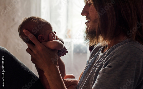 Father Holding a Newborn Baby