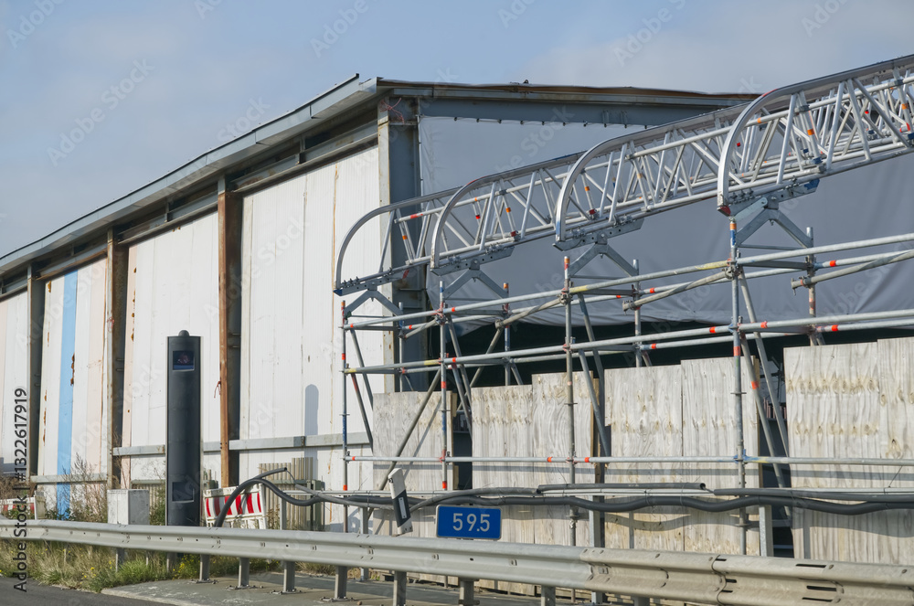 Industrial Building with Scaffolding and Highway Sign Industrial Building with Scaffolding and Highway Sign