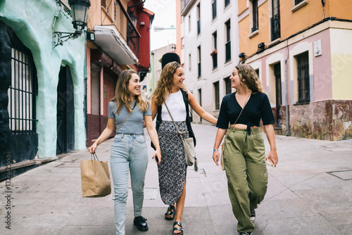 Three young women walking down the street after shopping
