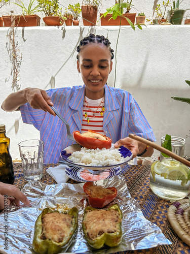 UGC African young woman serving Cape Verde typical food at home