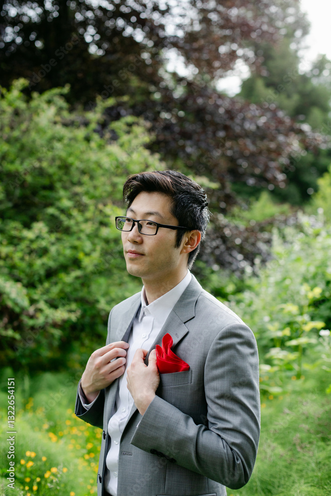 A Handsome Groom Poses for a Portrait on his Wedding Day A Handsome Groom Poses for a Portrait on his Wedding Day