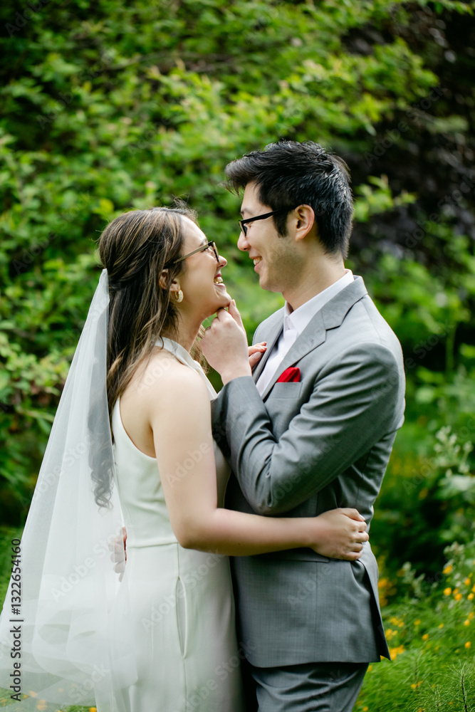 Smiling Bride and Groom Look into each other's Eyes Outdoors Smiling Bride and Groom Look into each other's Eyes Outdoors