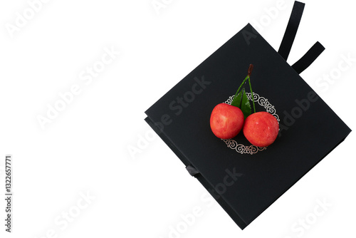 Elegant black gift box with blank white card and red cherries on a white background, perfect for branding or messaging  
