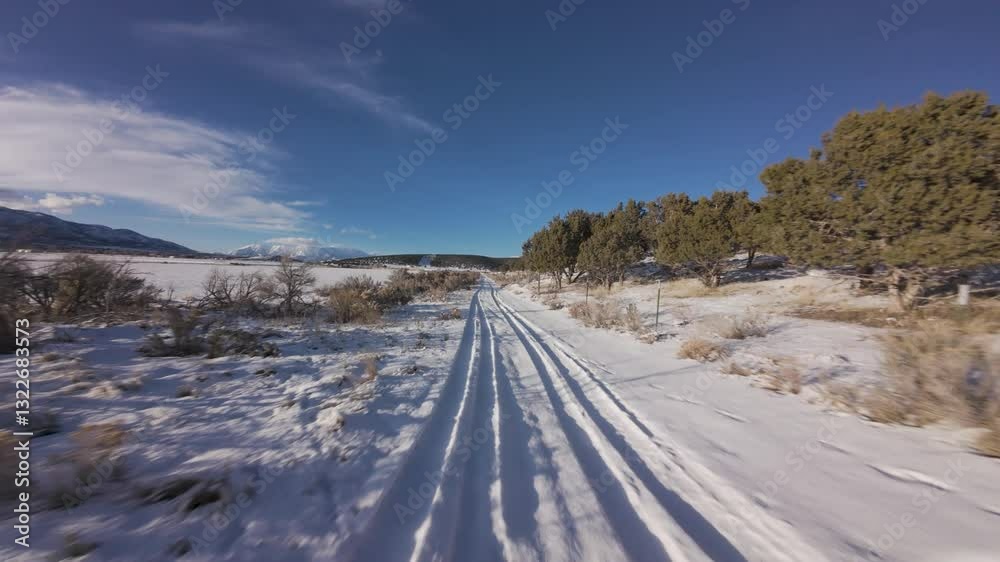Aerial-FPV-First person view- Flying low and fast over tire tracks on snowy country lane road Aerial-FPV-First person view- Flying low and fast over tire tracks on snowy country lane road