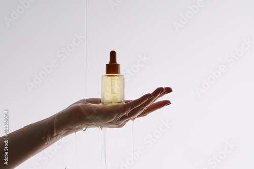A graceful hand holding a sleek perfume bottle, beautifully illu