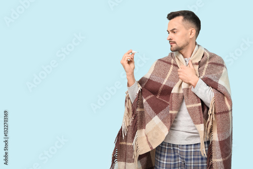 Sick young man with plaid a...