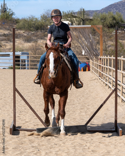 A woman doing an obstacle course with her horse
