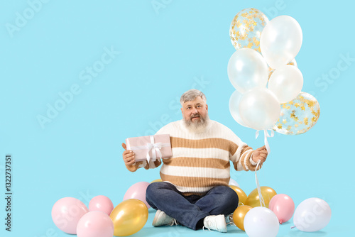 Senior man with many balloo...