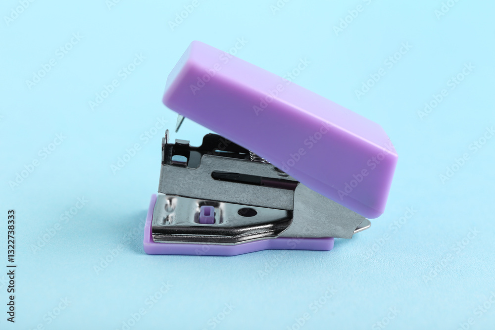 Lilac stapler on blue background Lilac stapler on blue background