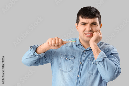 Young man with brush suffer...