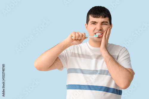 Young man with brush suffer...