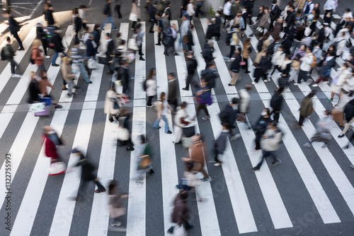 Crowded zebra crossing in motion from above