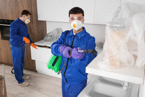 Male workers disinfecting i...