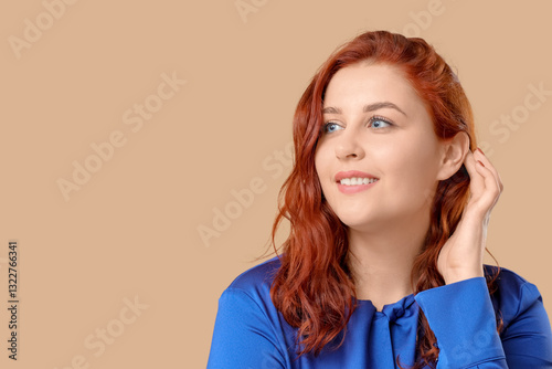 Smiling young redhead woman...