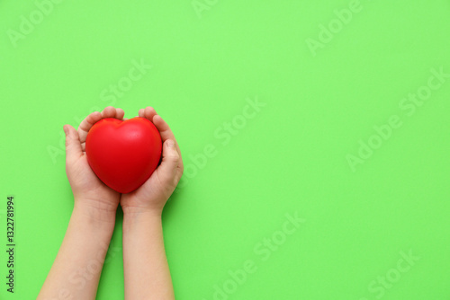 Child's hands with red hear...