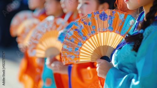 A Woman in a Blue Kimono Holds a Fan