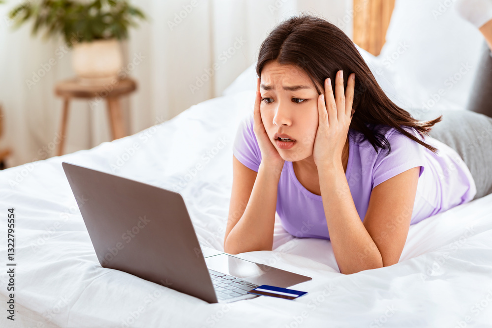 Fototapeta premium Online Shopping Problem. Shocked Asian Woman Having Issue Purchasing On Internet, Not Having Money On Bank Account At Home