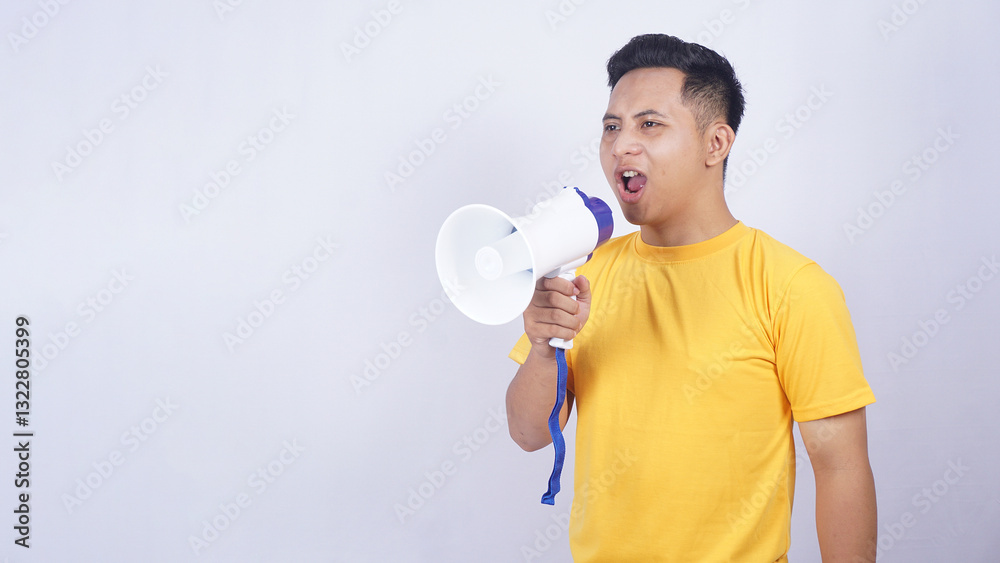 Portrait of Asian young man shouting on megaphone isolated on white background Portrait of Asian young man shouting on megaphone isolated on white background