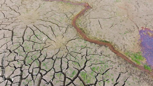  Chemical wastes close up. Dry and cracked ground background. Global warming and climate change. Environmental pollution by chemical waste. Ecological catastrophe