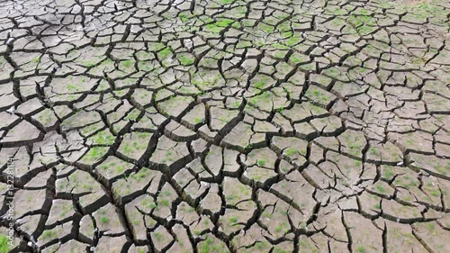  Chemical wastes close up. Dry and cracked ground background. Global warming and climate change. Environmental pollution by chemical waste. Ecological catastrophe